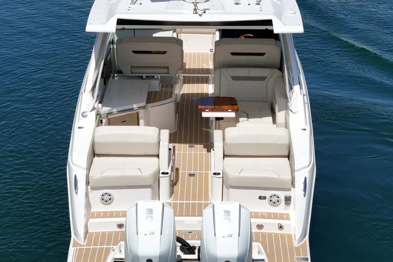 Slide: The Image of 2026 Tiara Yachts 34 LX luxury boat interior with seating and table on water. - 26
