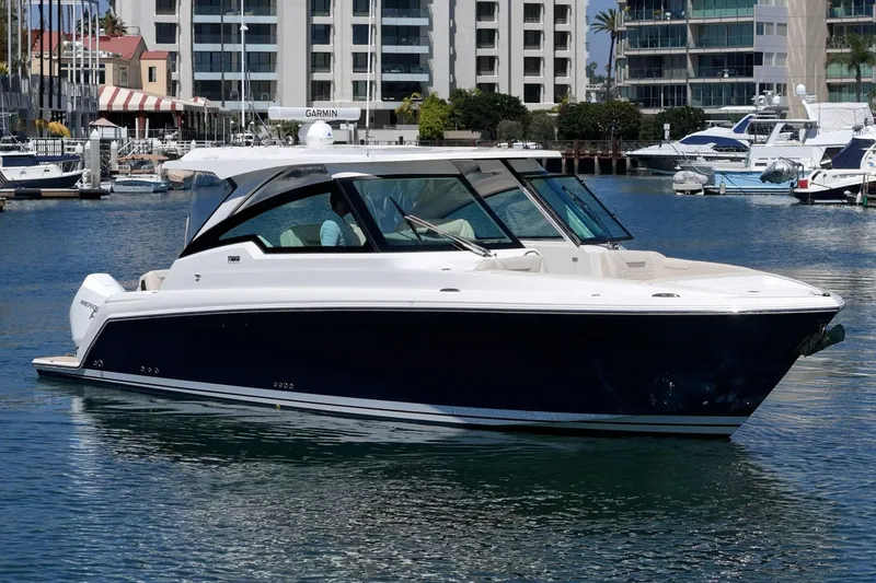 Slide: The Image of 2026 Tiara Yachts 34 LX in marina, sleek design, modern luxury boat. - 3