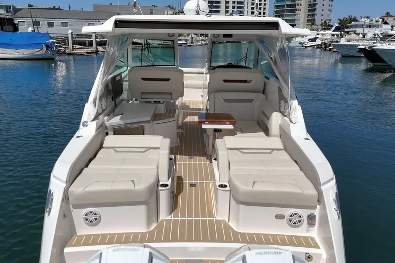 Slide: The Image of 2026 Tiara Yachts 34 LX luxury boat interior with beige seating and wooden flooring. - 30