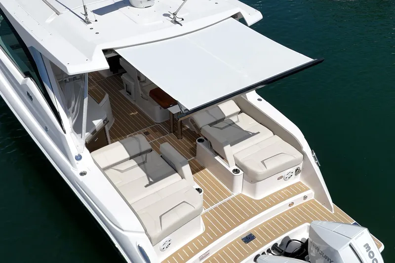 Slide: The Image of 2026 Tiara Yachts 34 LX with sunshade, luxurious seating, and sleek design on water. - 33