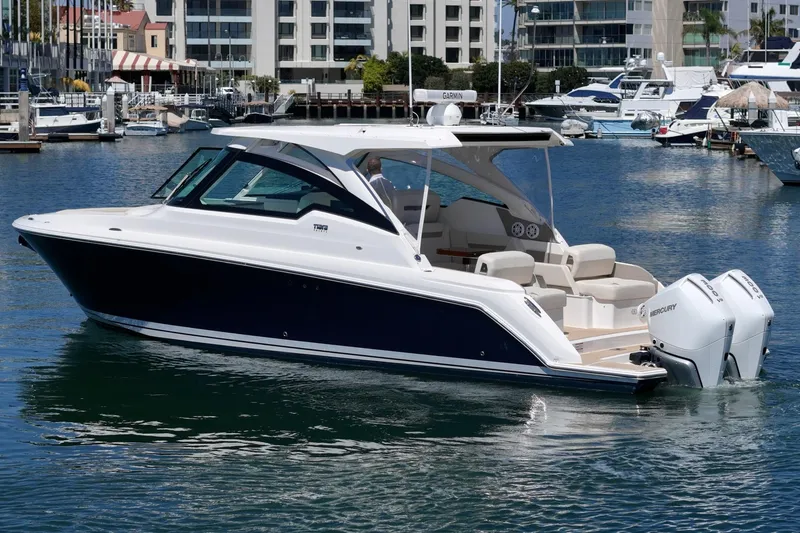 Slide: The Image of 2026 Tiara Yachts 34 LX in marina, showcasing sleek design and powerful engines. - 4