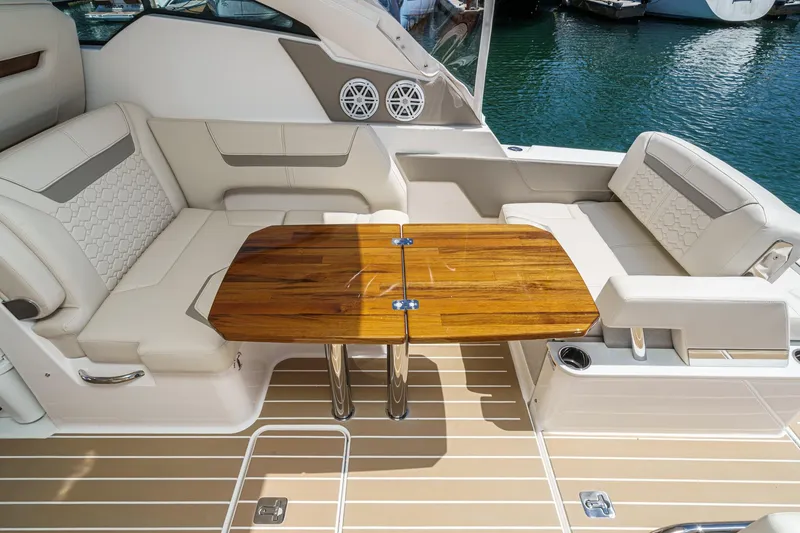 Slide: The Image of Luxurious seating area on 2026 Tiara Yachts 34 LX with elegant wooden table. - 41