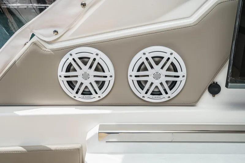 Slide: The Image of 2026 Tiara Yachts 34 LX featuring dual JL Audio speakers on beige panel. - 45