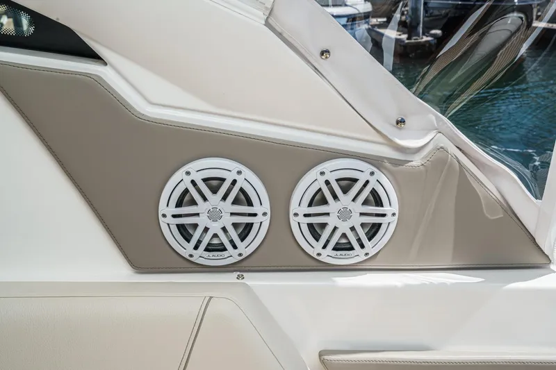 Slide: The Image of 2026 Tiara Yachts 34 LX featuring dual JL Audio speakers on beige panel. - 46