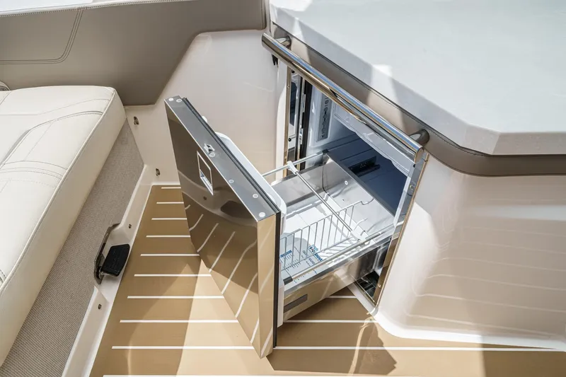 Slide: The Image of 2026 Tiara Yachts 34 LX interior with open stainless steel refrigerator drawer. - 47