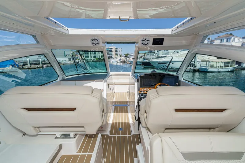 Slide: The Image of Interior view of 2026 Tiara Yachts 34 LX, showcasing luxurious seating and helm. - 48
