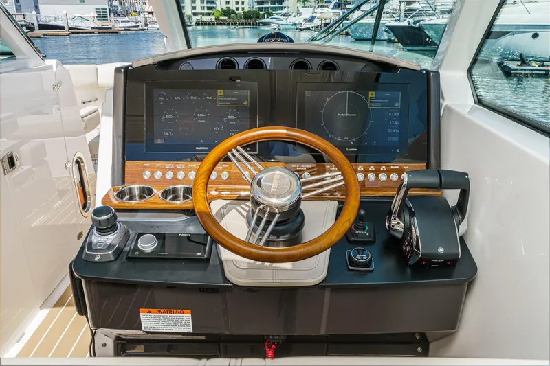 Slide: The Image of Helm of 2026 Tiara Yachts 34 LX with modern navigation displays and controls. - 53