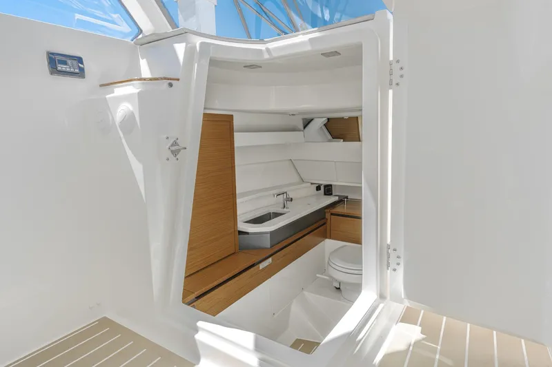 Slide: The Image of 2026 Tiara Yachts 34 LX interior with modern bathroom and sleek design. - 57