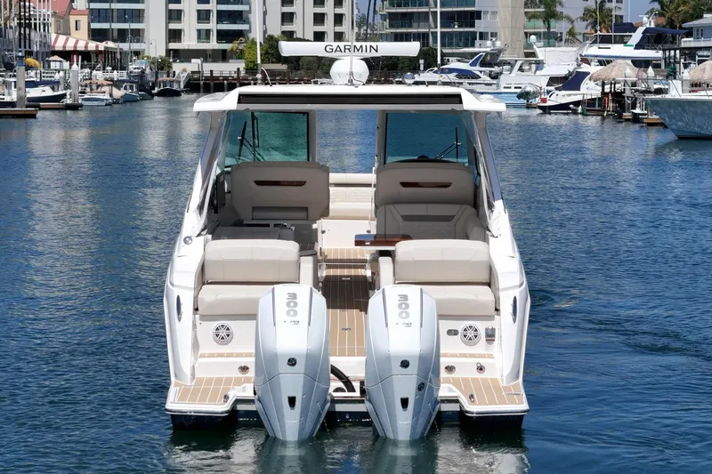 Slide: The Image of 2026 Tiara Yachts 34 LX with twin engines docked in a marina. - 6