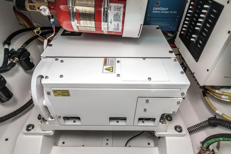 Slide: The Image of Engine compartment of 2026 Tiara Yachts 34 LX, featuring electrical systems and fire extinguisher. - 61