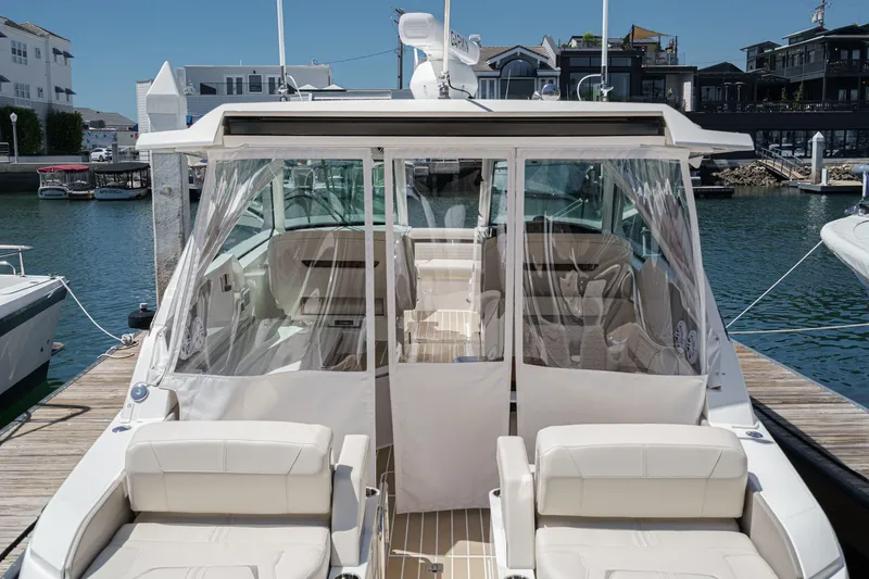 Slide: The Image of 2026 Tiara Yachts 34 LX docked, showcasing luxurious seating and sleek design. - 62