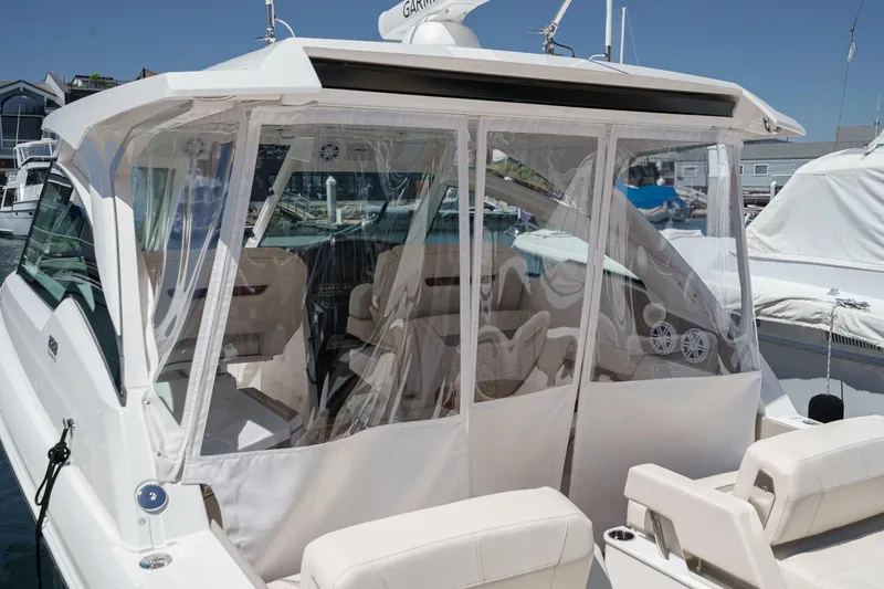 Slide: The Image of 2026 Tiara Yachts 34 LX with enclosed cockpit, docked at marina. - 63