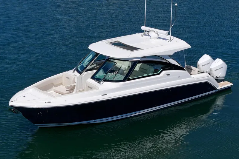 Slide: The Image of 2026 Tiara Yachts 34 LX boat on water, featuring sleek design and twin Mercury engines. - 9