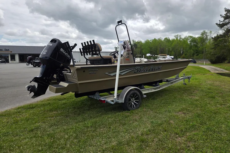 Slide: The Image of 2024 SeaArk 2072 FX boat on trailer with Suzuki outboard motor, parked on grass. - 4