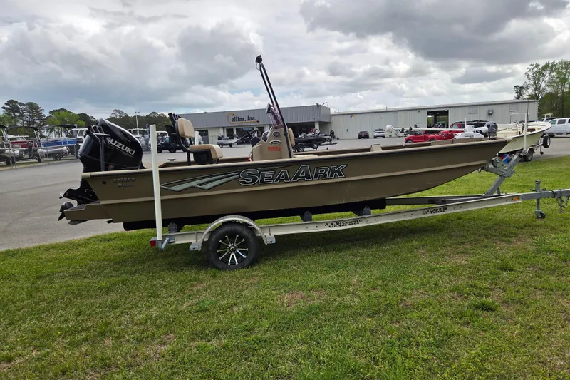 Slide: The Image of 2024 SeaArk 2072 FX boat on trailer, parked outdoors under cloudy sky. - 5