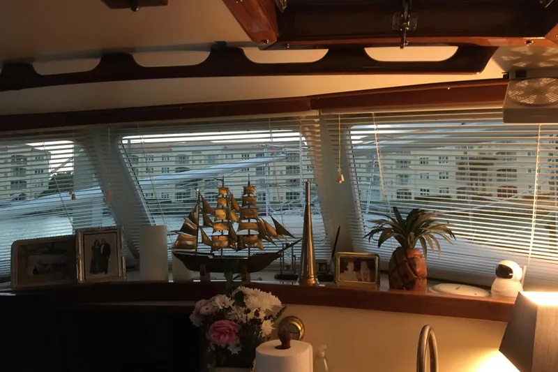 Slide: The Image of Cozy cabin interior of a 1973 CAL 2-46 sailboat with decorative pillows and personal items. - 11