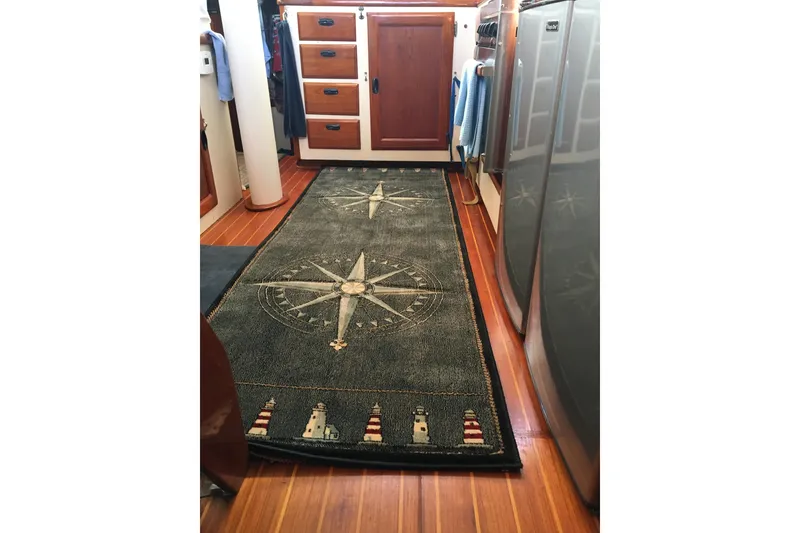 Slide: The Image of Cozy boat interior with nautical-themed pillows, books, and decorative flowers, CAL 2-46, 1973. - 12