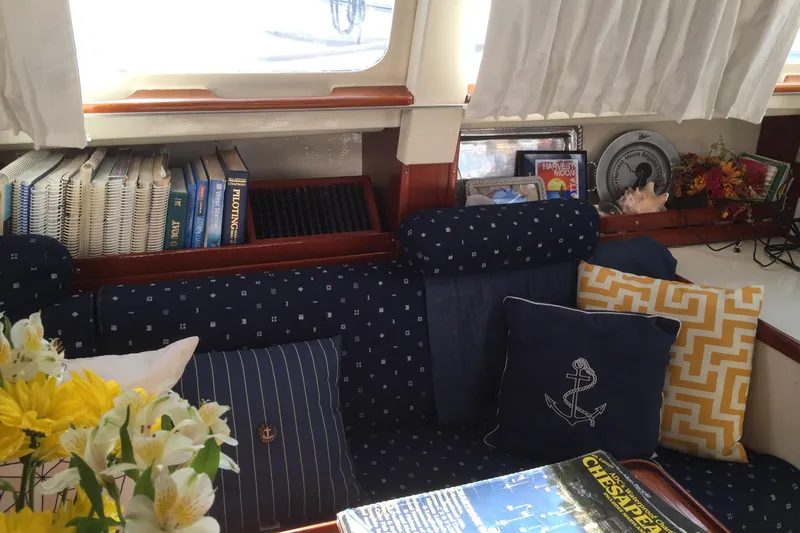 Slide: The Image of Engine of a 1973 CAL 2-46 sailboat, featuring blue components and wooden cover. - 14