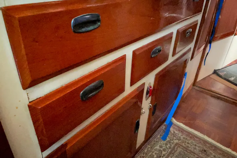 Slide: The Image of 1973 CAL 2-46 engine compartment with blue machinery and wooden cover. - 15