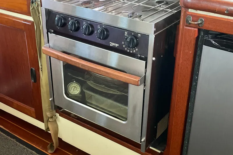 Slide: The Image of 1973 CAL 2-46 yacht kitchen with stainless steel oven and wooden cabinetry. - 8