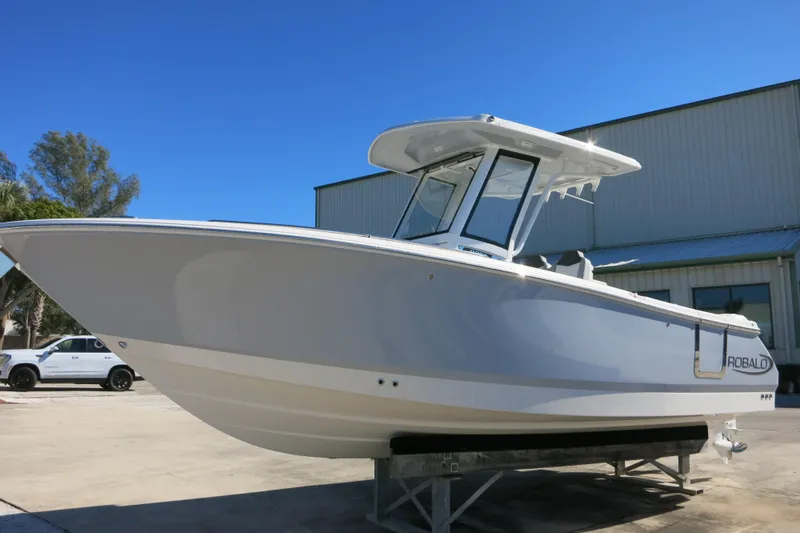 The Image of 2026 Robalo R250 Center Console boat displayed outdoors on a sunny day. - 0