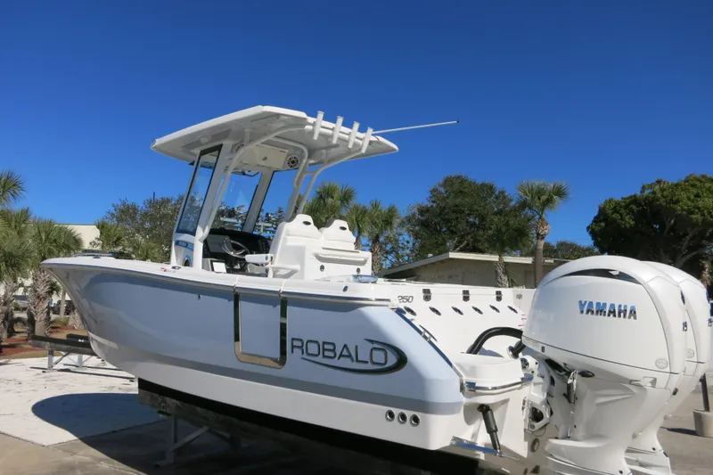 Slide: The Image of 2026 Robalo R250 Center Console boat with Yamaha engine, parked outdoors. - 10