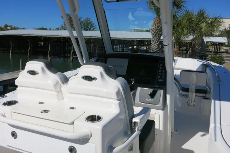 Slide: The Image of 2026 Robalo R250 Center Console boat interior with dual seats and control panel. - 12