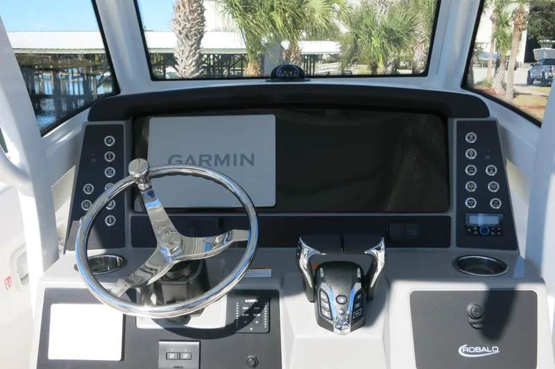 Slide: The Image of 2026 Robalo R250 Center Console boat dashboard with Garmin navigation system. - 13