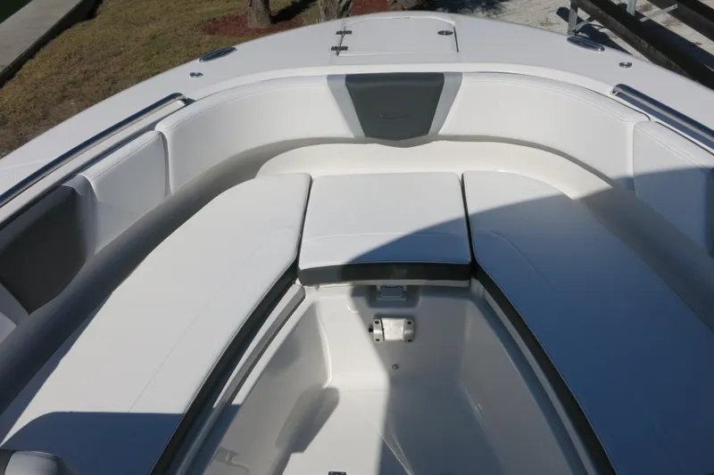 Slide: The Image of 2026 Robalo R250 Center Console boat interior with cushioned seating area. - 15