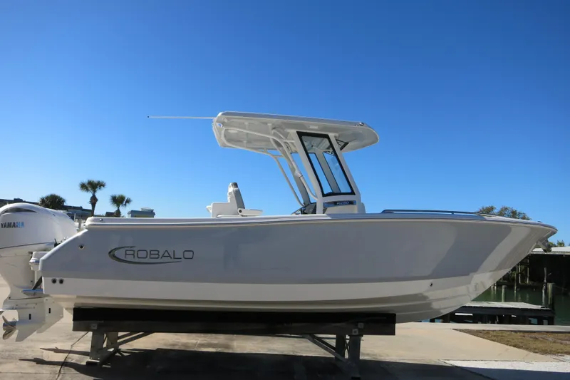 Slide: The Image of 2026 Robalo R250 Center Console boat on display, featuring sleek design and Yamaha engine. - 2