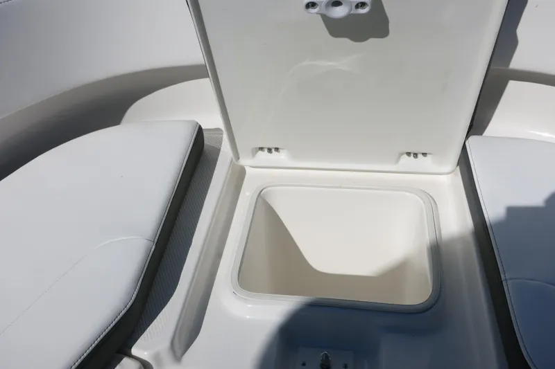 Slide: The Image of 2026 Robalo R250 Center Console boat storage compartment with open lid. - 20