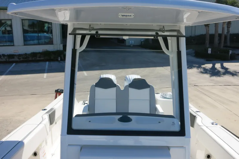 Slide: The Image of 2026 Robalo R250 Center Console boat interior with dual seats and T-top. - 22
