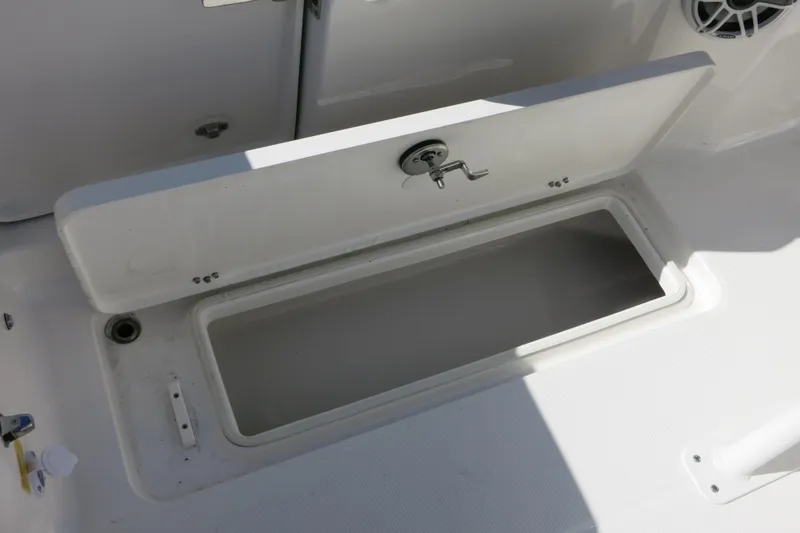 Slide: The Image of Open storage compartment on 2026 Robalo R250 Center Console boat. - 23