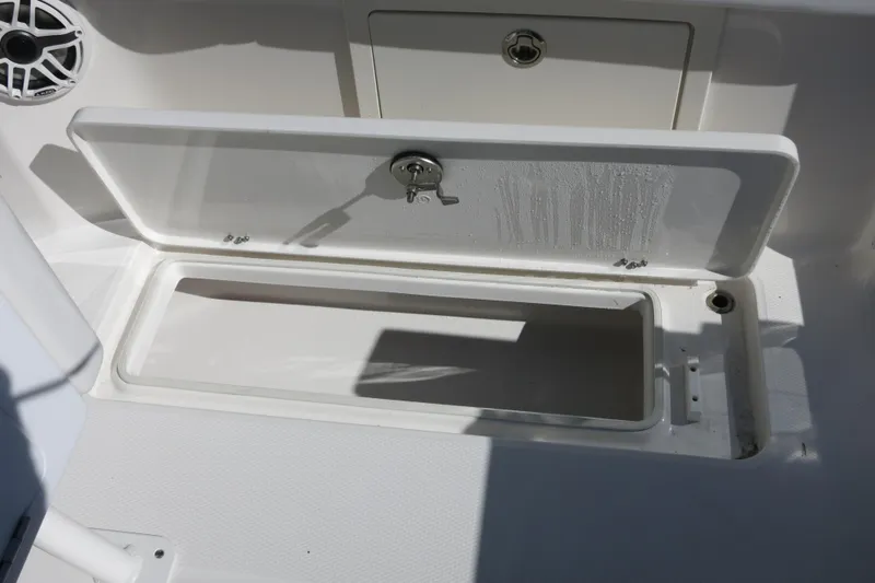 Slide: The Image of Open storage compartment on 2026 Robalo R250 Center Console boat. - 24