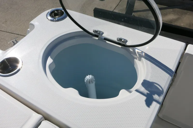 Slide: The Image of Livewell on 2026 Robalo R250 Center Console boat, open lid, white textured surface. - 27