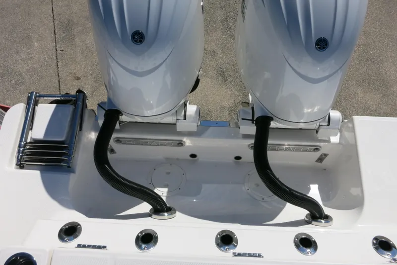 Slide: The Image of 2026 Robalo R250 Center Console boat with dual outboard engines and ladder. - 28