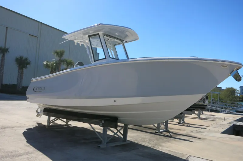 Slide: The Image of 2026 Robalo R250 Center Console boat displayed outdoors on a stand. - 5