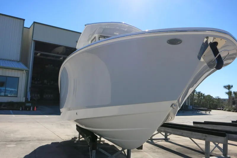 Slide: The Image of 2026 Robalo R250 Center Console boat on display outside a warehouse. - 6