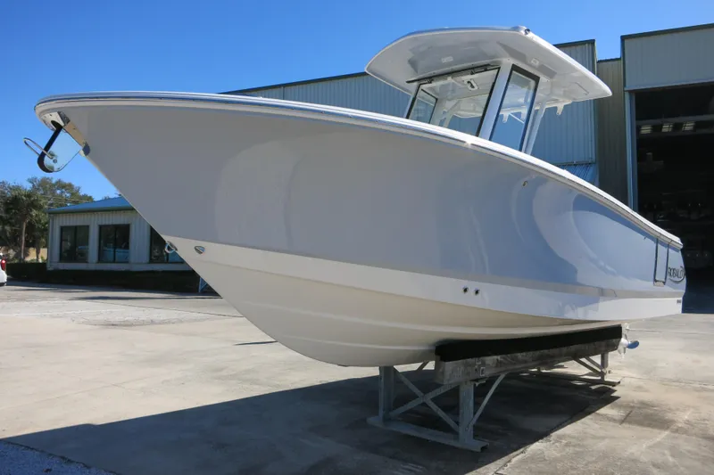 Slide: The Image of 2026 Robalo R250 Center Console boat on display outdoors. - 8