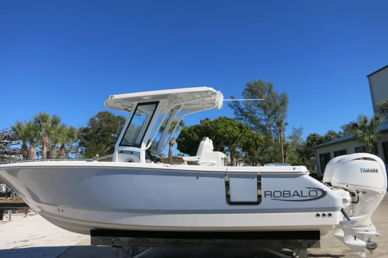 Slide: The Image of 2026 Robalo R250 Center Console boat with Yamaha engine, parked outdoors. - 9