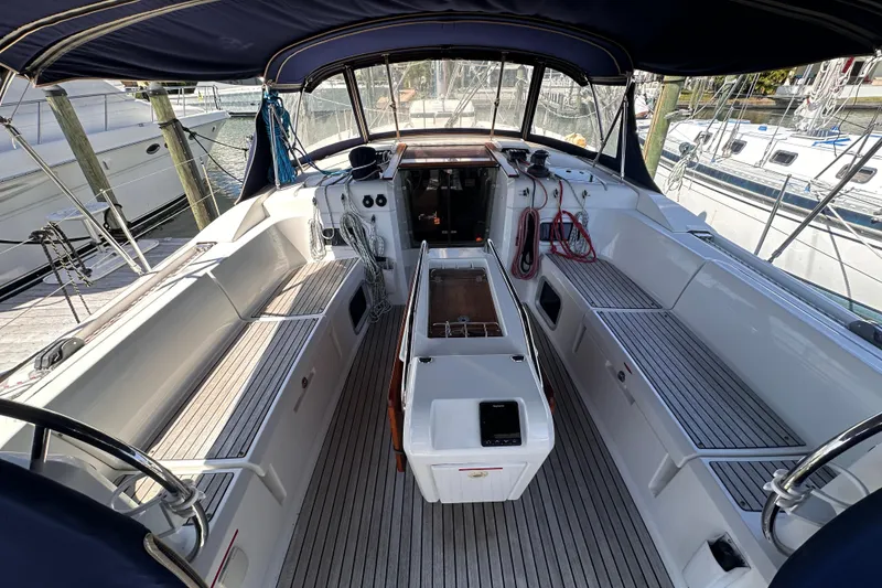Slide: The Image of Cockpit of 2015 Jeanneau Sun Odyssey 469 sailboat, featuring spacious seating and navigation equipment. - 11