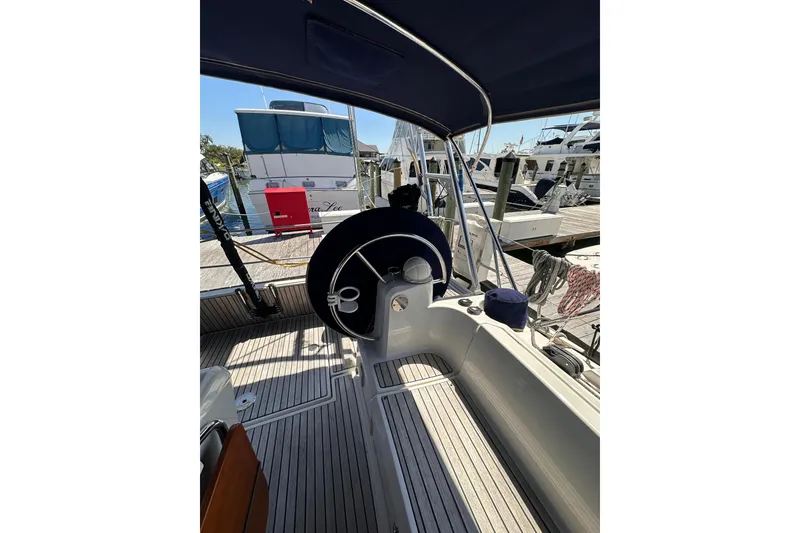 Slide: The Image of 2015 Jeanneau Sun Odyssey 469 yacht cockpit with steering wheel, docked at marina. - 13