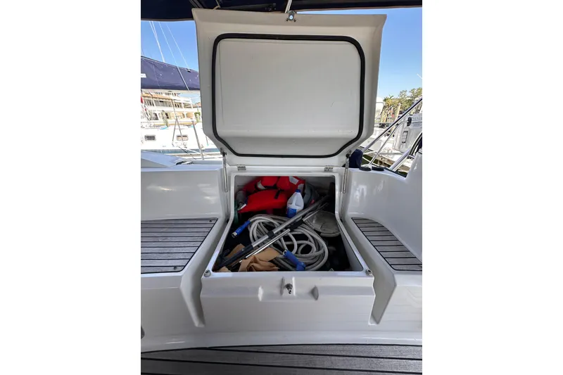 Slide: The Image of Open storage compartment on 2015 Jeanneau Sun Odyssey 469 sailboat, containing boating equipment. - 15
