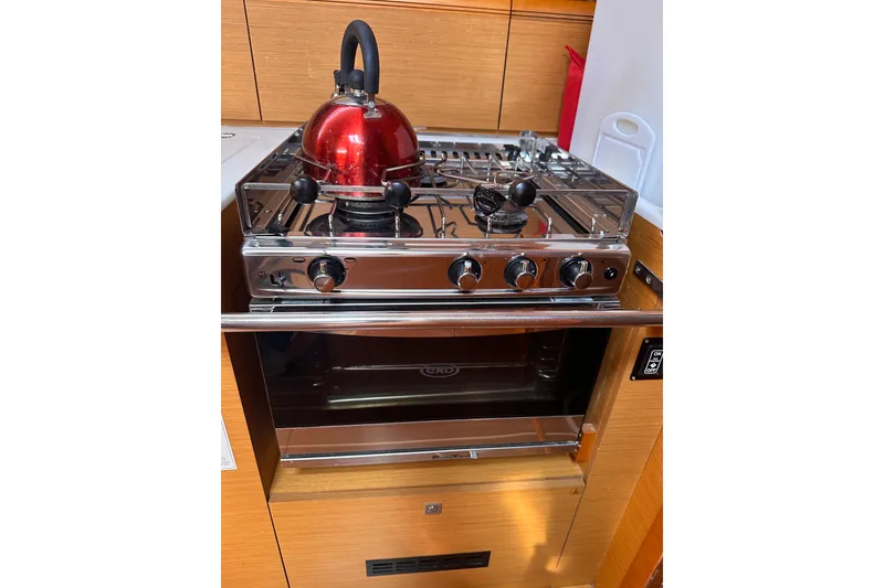 Slide: The Image of Stove and oven in Jeanneau Sun Odyssey 469 yacht, featuring a red kettle. - 19
