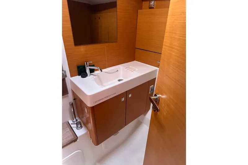 Slide: The Image of Bathroom interior of 2015 Jeanneau Sun Odyssey 469 yacht, featuring modern sink and wood finish. - 22
