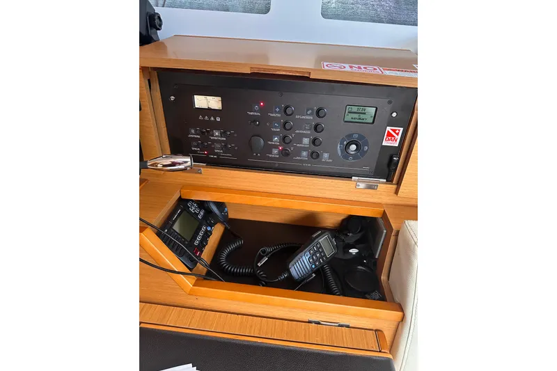 Slide: The Image of Control panel of 2015 Jeanneau Sun Odyssey 469 sailboat with communication equipment. - 26