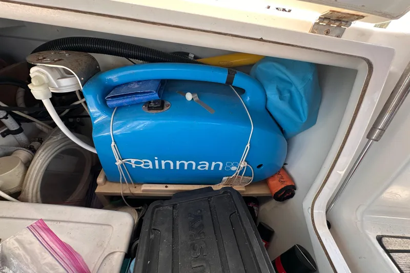 Slide: The Image of Storage compartment on Jeanneau Sun Odyssey 469, featuring a blue Rainman watermaker. - 27
