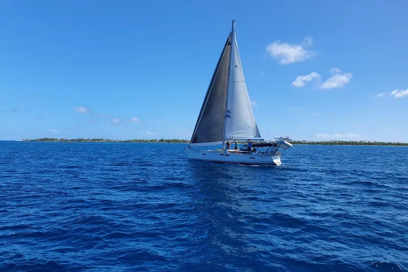 Slide: The Image of 2015 Jeanneau Sun Odyssey 469 sailing on open blue ocean under clear sky. - 29