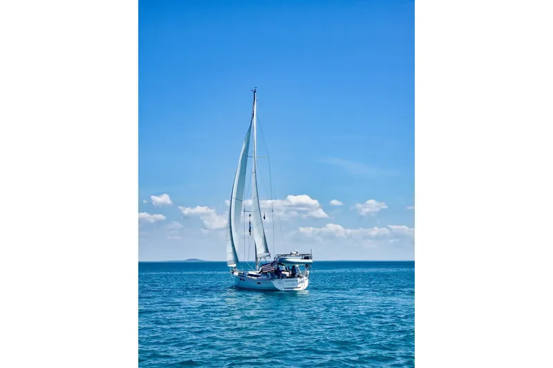 Slide: The Image of 2015 Jeanneau Sun Odyssey 469 sailing on a clear blue sea under a bright sky. - 3