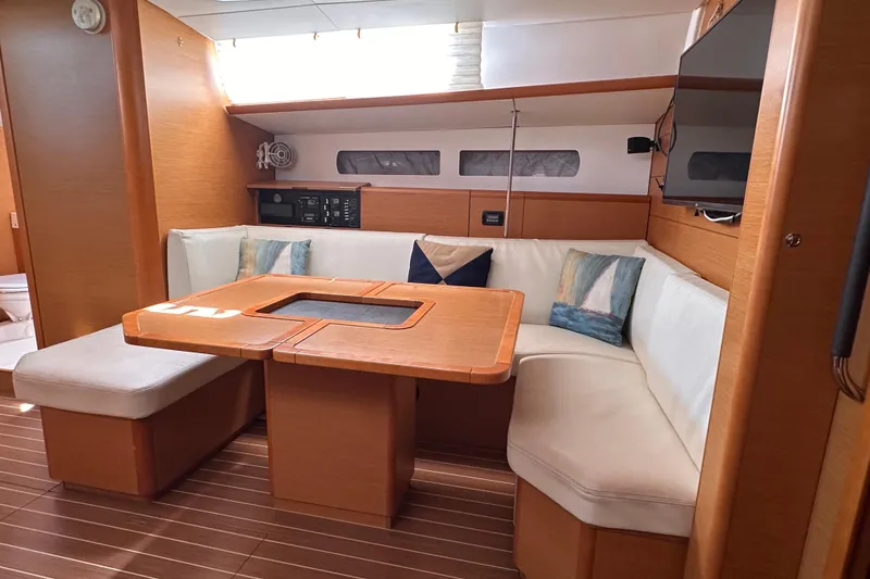 Slide: The Image of Interior of 2015 Jeanneau Sun Odyssey 469 yacht with cozy seating and wooden table. - 30